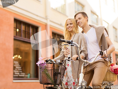 Image of couple with bicycles in the city