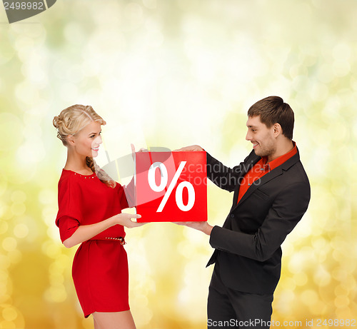 Image of smiling woman and man with red percent sale sign