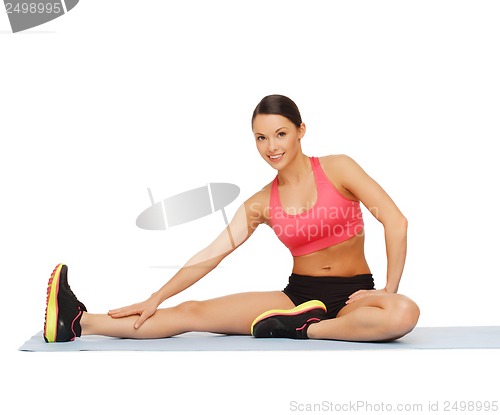 Image of sporty woman doing exercise on the floor