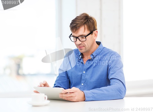 Image of man working with tablet pc at home
