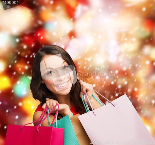 Image of woman in red dress with shopping bags