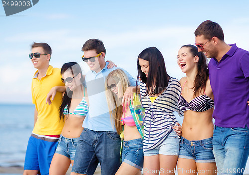 Image of group of friends having fun on the beach