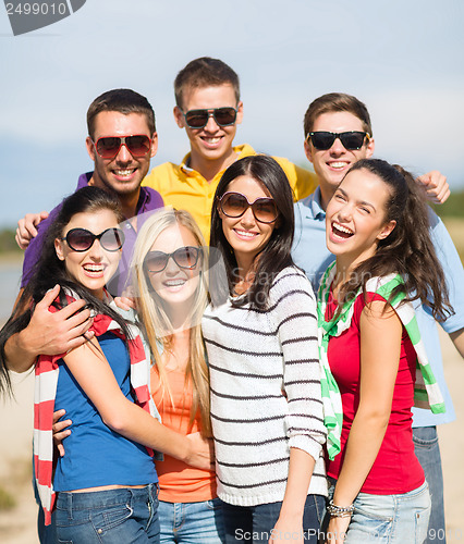 Image of group of friends having fun on the beach