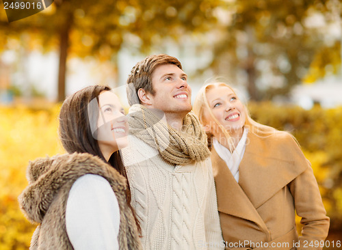 Image of group of friends having fun in autumn park