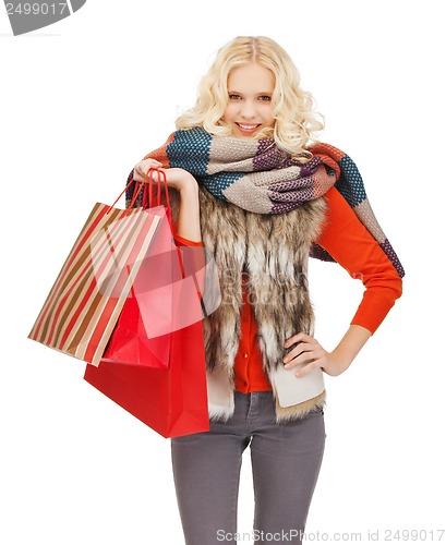 Image of teenage girl in winter clothes with shopping bags