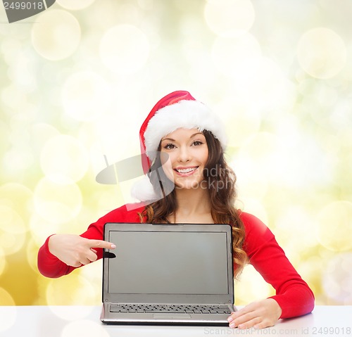 Image of woman in santa helper hat with laptop computer