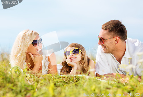 Image of happy family with blue sky and green grass