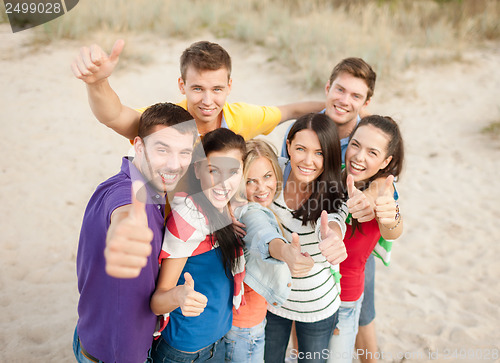 Image of group of friends having fun on the beach