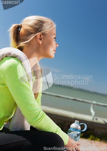 Image of woman resting after doing sports outdoors