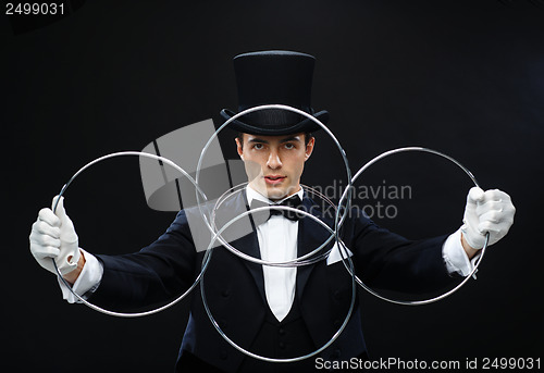 Image of magician showing trick with linking rings