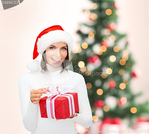 Image of smiling woman in santa helper hat with gift box