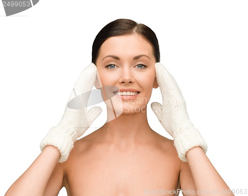 Image of smiling young woman in white mittens