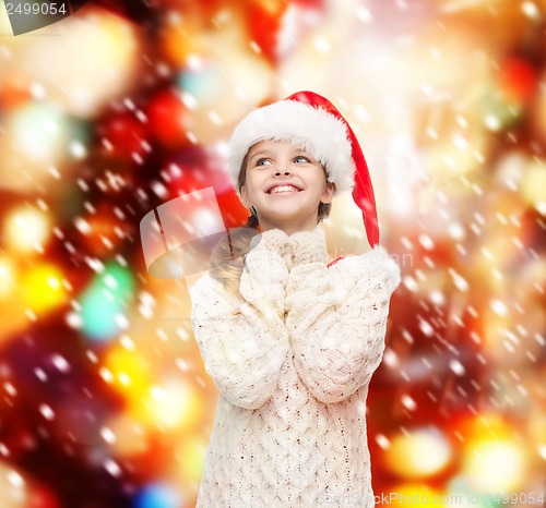 Image of dreaming girl in santa helper hat