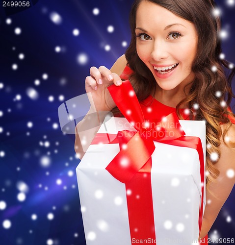Image of smiling woman in red dress with gift box