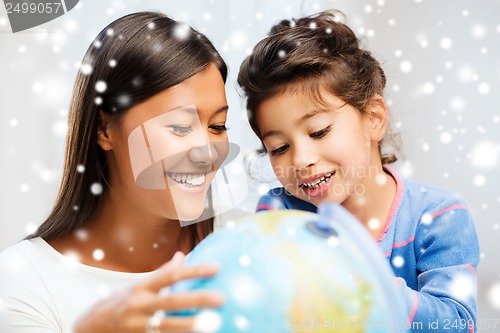 Image of mother and daughter with globe