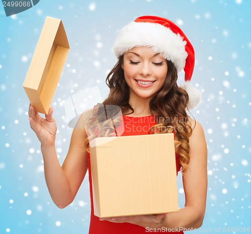 Image of smiling woman in santa helper hat with gift box