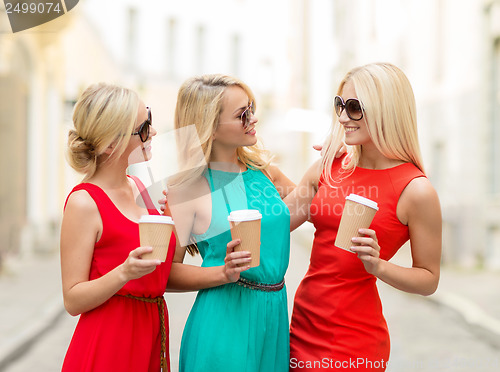 Image of women with takeaway coffee cups in the city