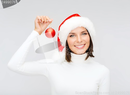 Image of woman in santa helper hat with christmas ball