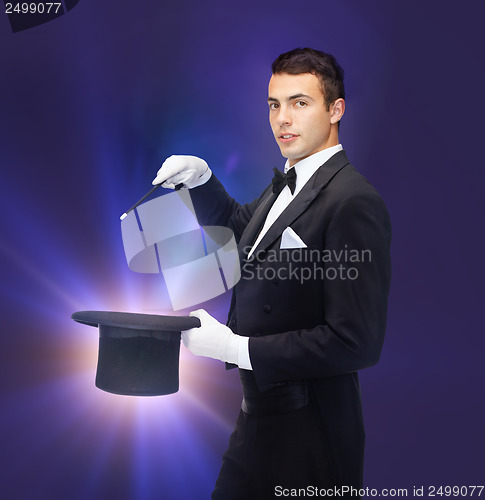 Image of magician in top hat with magic wand showing trick