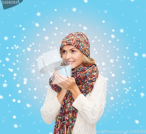 Image of woman in hat with red tea or coffee mug