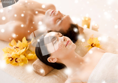 Image of couple in spa salon lying on the massage desks