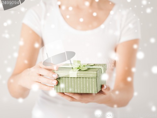 Image of woman hands with gift box