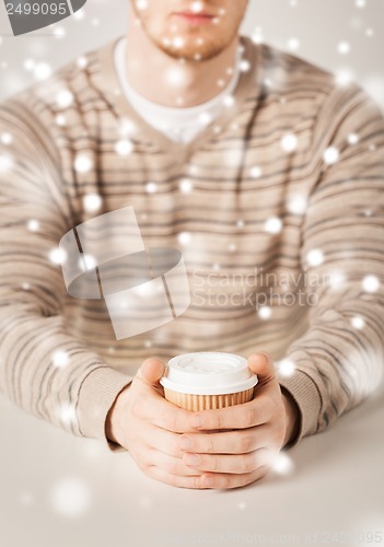 Image of man hand holding take away coffee cup
