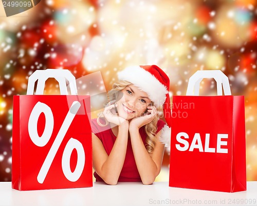 Image of woman in red dress with shopping bags
