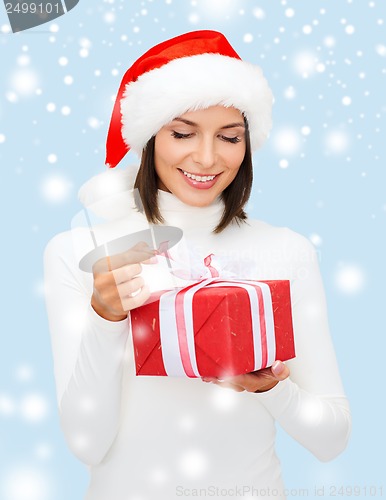 Image of smiling woman in santa helper hat with gift box