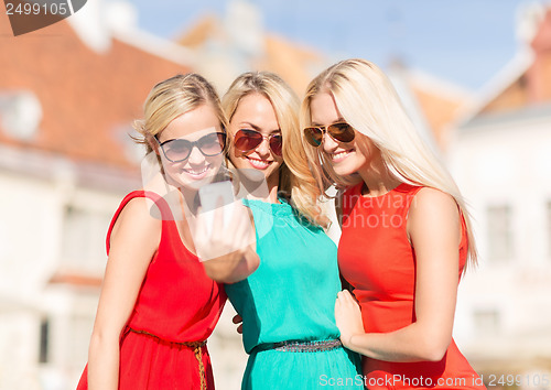 Image of beautiful girls taking picture in the city