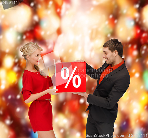 Image of smiling woman and man with red percent sale sign