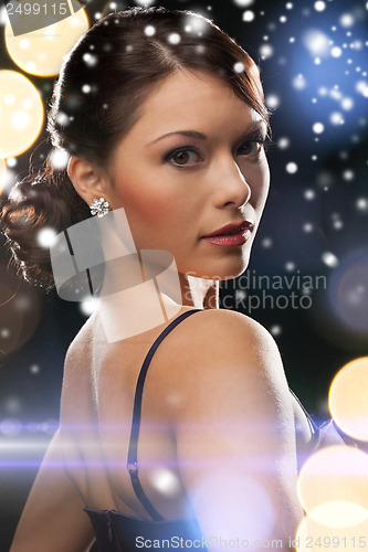 Image of woman in evening dress wearing diamond earrings