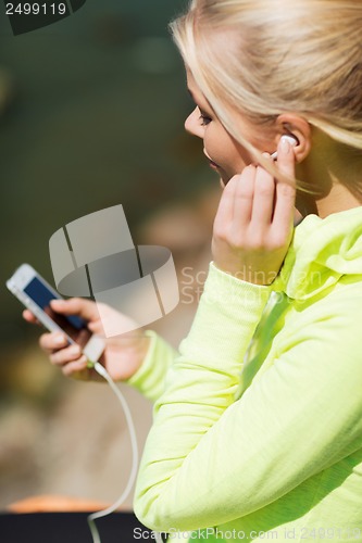 Image of woman listening to music outdoors