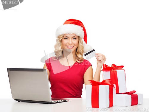 Image of woman with gifts, laptop computer and credit card