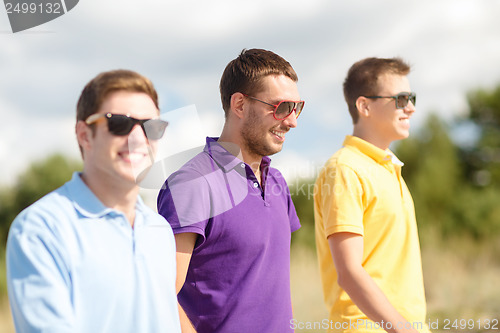 Image of group of friends walking on the beach