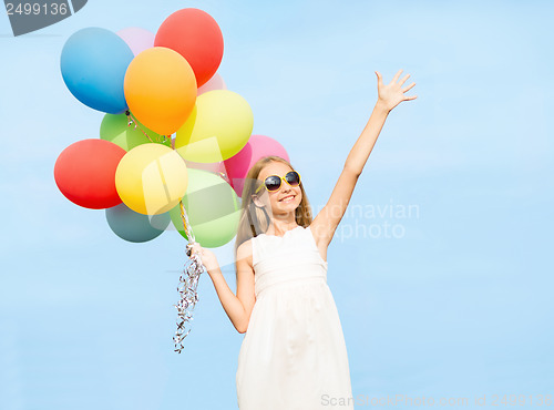 Image of happy girl with colorful balloons