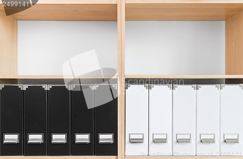 Image of Bookcase with black and white folders