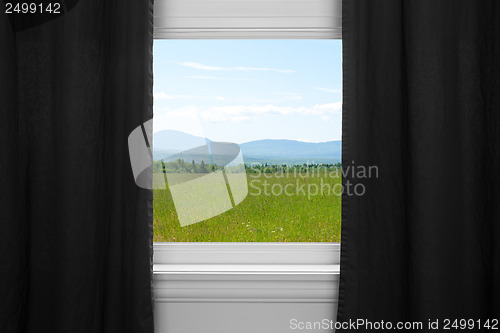 Image of Summer landscape behind black curtains