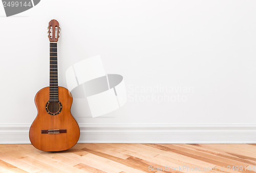 Image of Classical guitar in an empty room