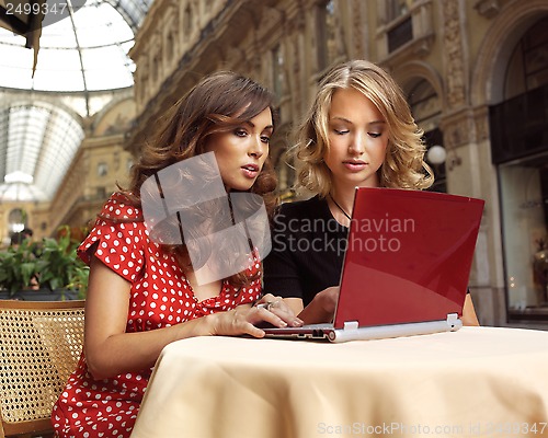 Image of happy businesswomen with laptop