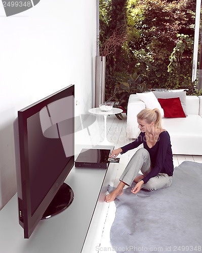 Image of Woman with CD at home