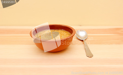 Image of Bowl of vegetable soup with a spoon 