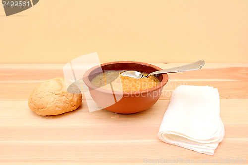 Image of Bowl of lentil soup with a bread roll