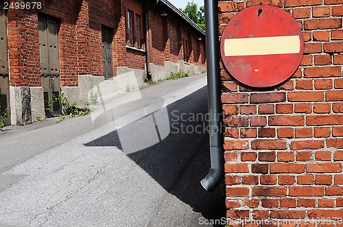 Image of no entry sign on a brick wall