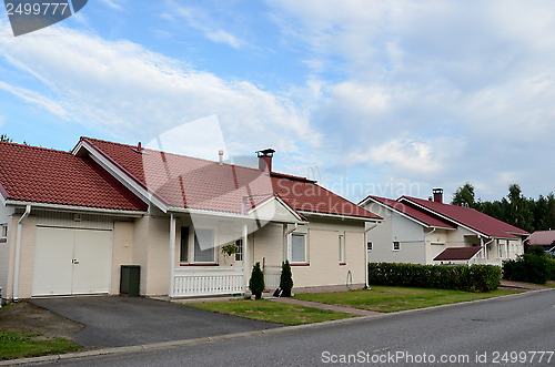 Image of several low-rise houses near the forest