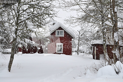 Image of Red house in snowfall