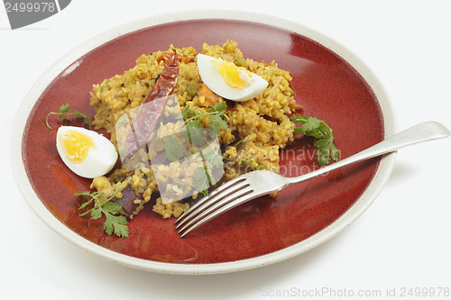 Image of Kichuri plate and fork with egg