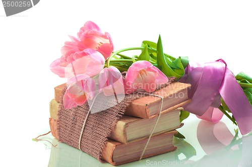 Image of Pink tulips on old books