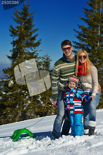 Image of family having fun on fresh snow at winter vacation