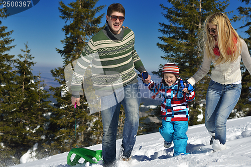 Image of family having fun on fresh snow at winter vacation